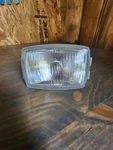 1986 Kawasaki Bayou KLF185 Headlamp Assembly 23004-1176 Used. Price: $45.00.
